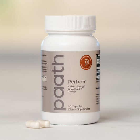 Supplement bottle labeled 'paath' with two capsules on a light background